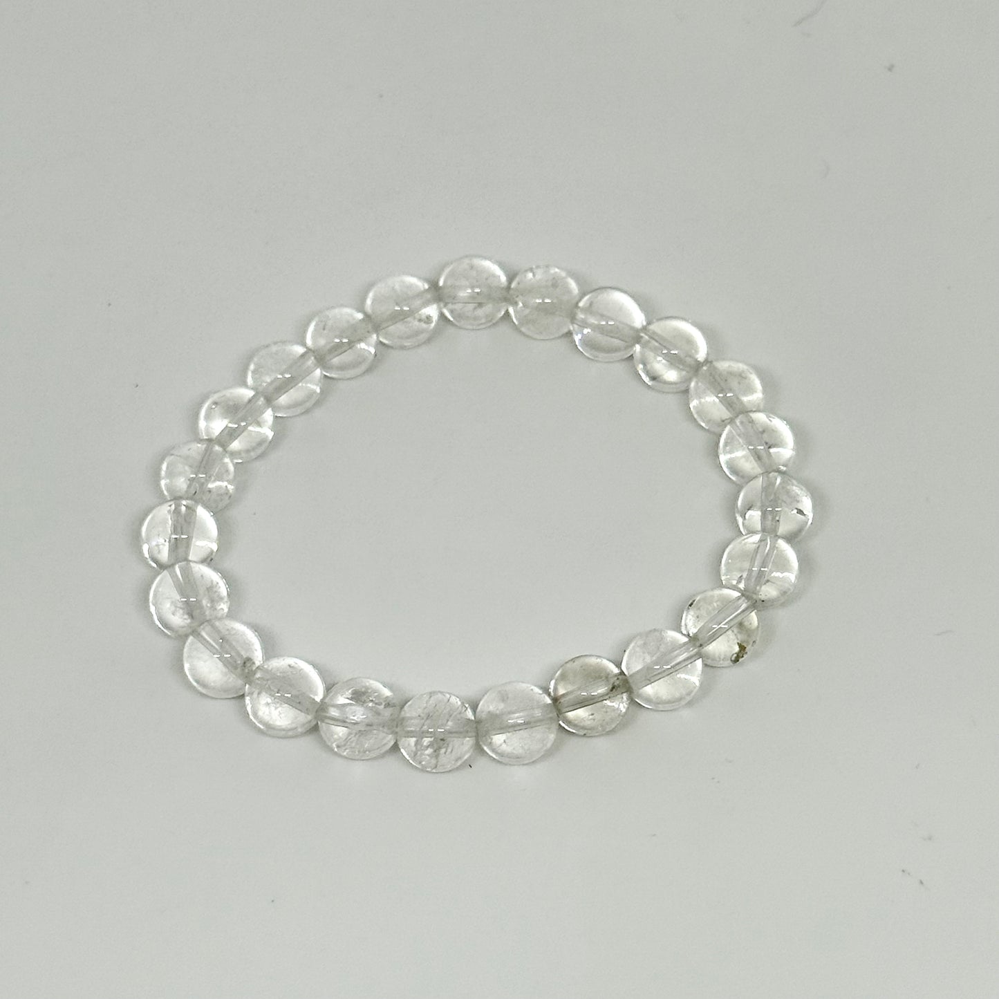 Clear quartz crystal bracelet on white background - healing energy jewelry Australia